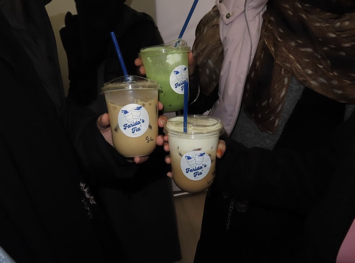 Three Farida's Fix iced drinks held by guests at an event