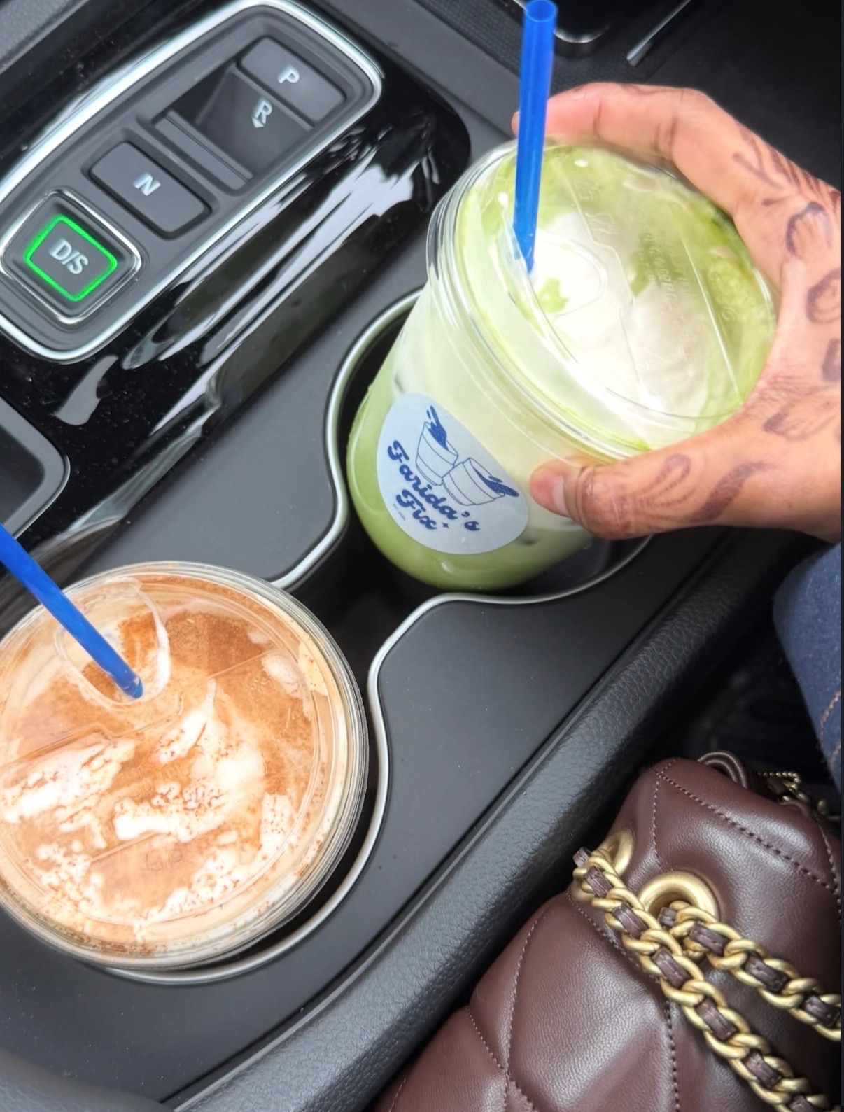 Two Farida's Fix drinks — matcha and chocolate — held in a car